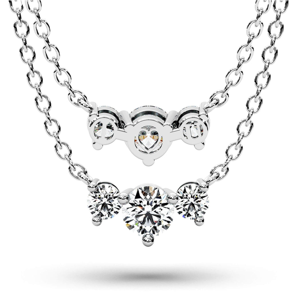 A silver-tone double-strand necklace featuring a top heart-shaped clasp with a central round gemstone and a lower cluster of three round-cut gemstones, shown on a white background with a soft shadow.